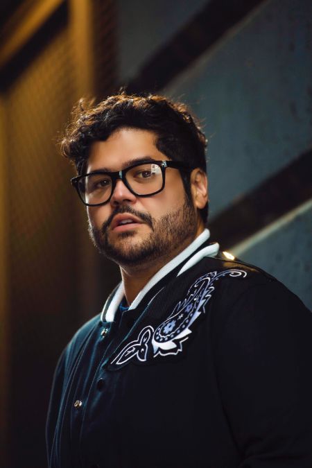 harvey wearing a black jacket with glasses on posing 